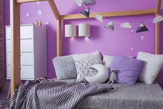 Comfortable bed in stylish child's room interior