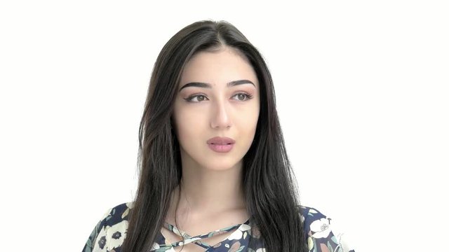 portrait of a young beautiful hispanic girl looking at the camera.brunette correct her hair