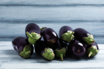 Tasty raw ripe eggplants on wooden table