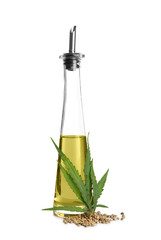 Bottle with hemp oil, leaf and seeds on white background
