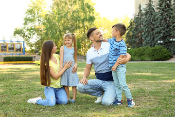 Fototapeta premium Happy family with children spending time together in green park on sunny day