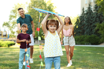 Happy family with children spending time together in green park on sunny day