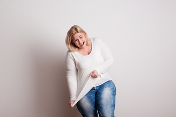 Portrait of an attractive overweight woman in studio on a white background.
