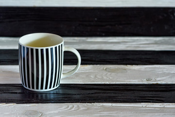 black-and-white ceramic cup on a wooden background