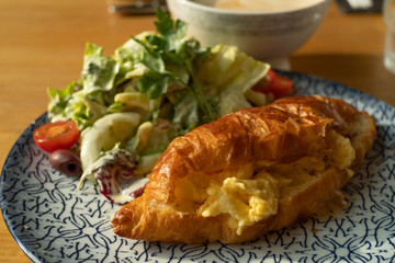 Breakfast Egg Croissant with salad for breakfast