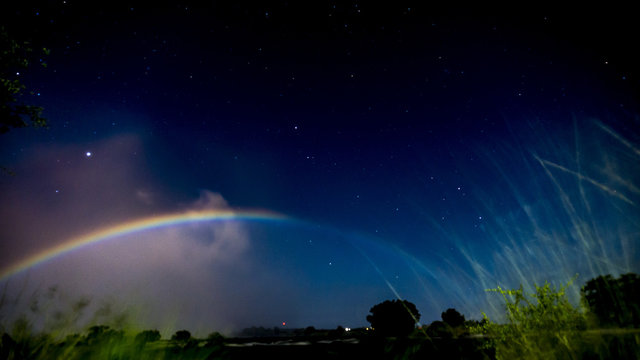 A lunar rainbow(Moonbow) at night, Victoria Falls, Zambia, Africa