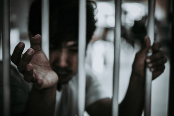 Hands of men desperate to catch the iron prison,prisoner concept,thailand people,Hope to be free.