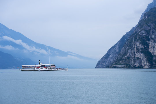 Ancient paddle wheel boat on Lake Garda (Lago di Garda), northern Italy in a foggy day.