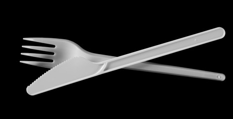 plastic white fork and knife isolated on black background, top view, clipping path