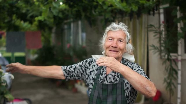 Grandmother shows a fashionable youth movement dab. Modern dance, sense of humor