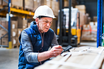Portrait of a senior male warehouse worker or a supervisor. - Powered by Adobe