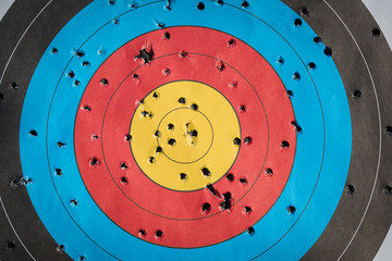 Practice target used for shooting with bullet holes in it.