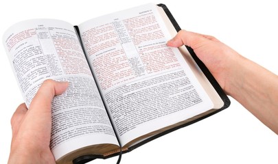 Closeup on Hands Holding an Open Bible