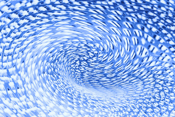 Spherical warp of space at edge of shot in blue. Fantastic background image of wormhole of metallic...