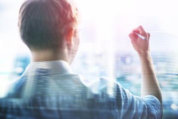 Businessman writing in the air with marker pen