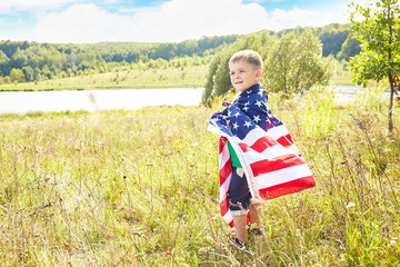Little boy with the flag of the United States of America.