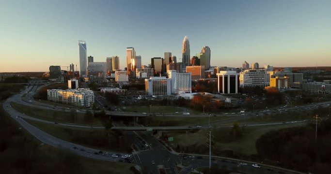 Wide aerial, sunset over Charlotte skyline