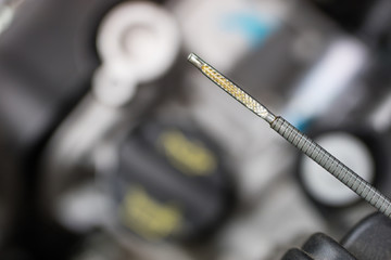 Car dipstick for oil level measurements. Checking the parameters of the car engine.