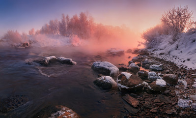 Winter Landscape In Pink Tones: Frosty Morning, River Blurred Water,Stones In Frazil And Sun In Fog.Belarus Landscape With Snowy Trees, Beautiful Frozen Foggy River And Winter Forest At Sunrise. - Powered by Adobe