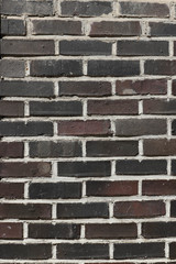 the textured wall of gray brick