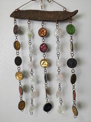 A colorful decoration made from bottle corks and chains