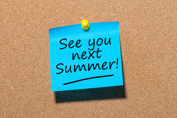 See you next Summer written on a note pinned at the office corkboard