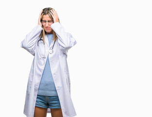 Young beautiful doctor woman headphones over isolated background suffering from headache desperate and stressed because pain and migraine. Hands on head.