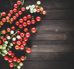 ripe red cherry tomatoes on a brown wooden board