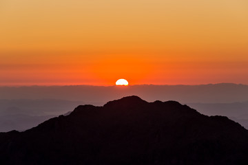 Rising sun and Sinai mountains dramatic landscape view (Mount Horeb, Gabal Musa, Moses Mount).