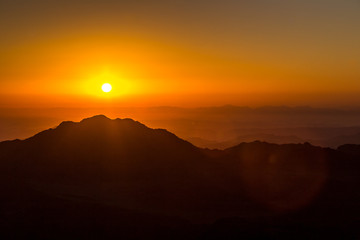 Image of a sunset. sun goes down over the mountains in the background. Mountain landscape. © matiplanas