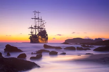 Wall murals Schip Old ship silhouette in sunset scenery, Italy