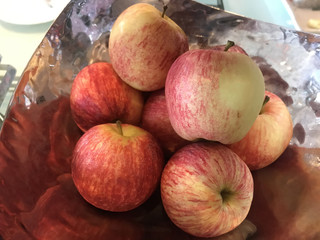 fresh raw red apples fruit stack piling in decorative stainless metal tray. Food, Natural Nutrition, Health care concept.