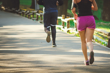 People are engaged in sports running in the morning in the park.