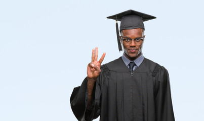 Young graduated african american man over isolated background showing and pointing up with fingers number three while smiling confident and happy.