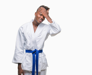 Young african american man over isolated background wearing kimono surprised with hand on head for mistake, remember error. Forgot, bad memory concept.