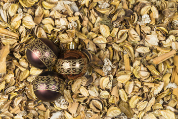 Christmas balls on dry leaves.