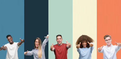 Group of people over vintage colors background approving doing positive gesture with hand, thumbs...