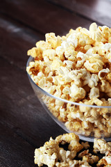 Cinema concept with popcorn on rustic table