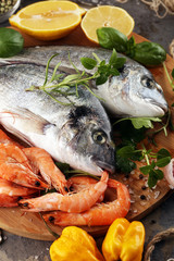 Delicious fresh fish. Fish with aromatic herbs, spices and vegetables - healthy food, diet or cooking concept.