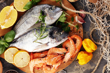 Delicious fresh fish. Fish with aromatic herbs, spices and vegetables - healthy food, diet or cooking concept.