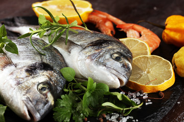 Delicious fresh fish. Fish with aromatic herbs, spices and vegetables - healthy food, diet or cooking concept.