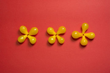 Creative flower food background. Yellow cherry tomatoes on red background top view