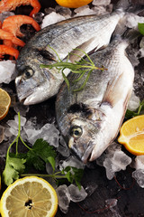 Delicious fresh fish. Fish with aromatic herbs, spices and vegetables - healthy food, diet or cooking concept.