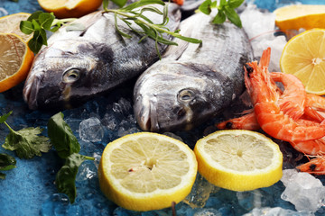 Delicious fresh fish. Fish with aromatic herbs, spices and vegetables - healthy food, diet or cooking concept.