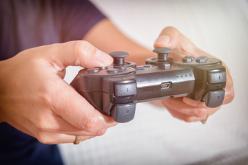 Woman plays video game using the gamepad