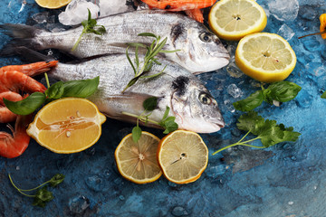 Delicious fresh fish. Fish with aromatic herbs, spices and vegetables - healthy food, diet or cooking concept.