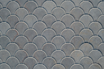 Gray paving slabs of original shape, texture.