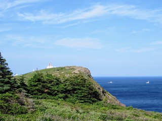 Beautiful day along the coast of Newfoundland viewing the lighthouse on Cape Spear.  Boats passing by along the open ocean.