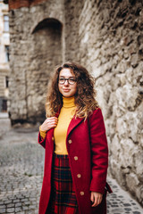 Cute girl with curly hair walking outdoor