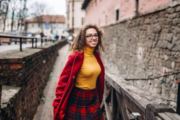 Cute girl with curly hair walking outdoor